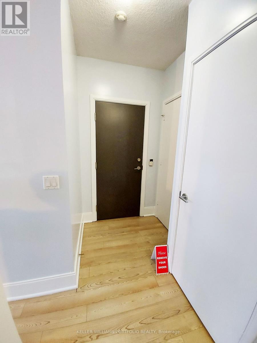 A hallway with a door on the left and a door on the right.