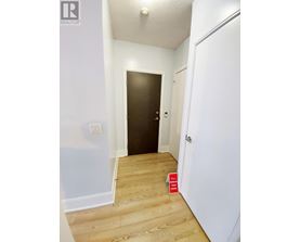 A hallway with a door on the left and a door on the right.