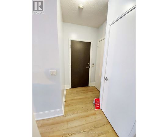 A hallway with a door on the left and a door on the right.