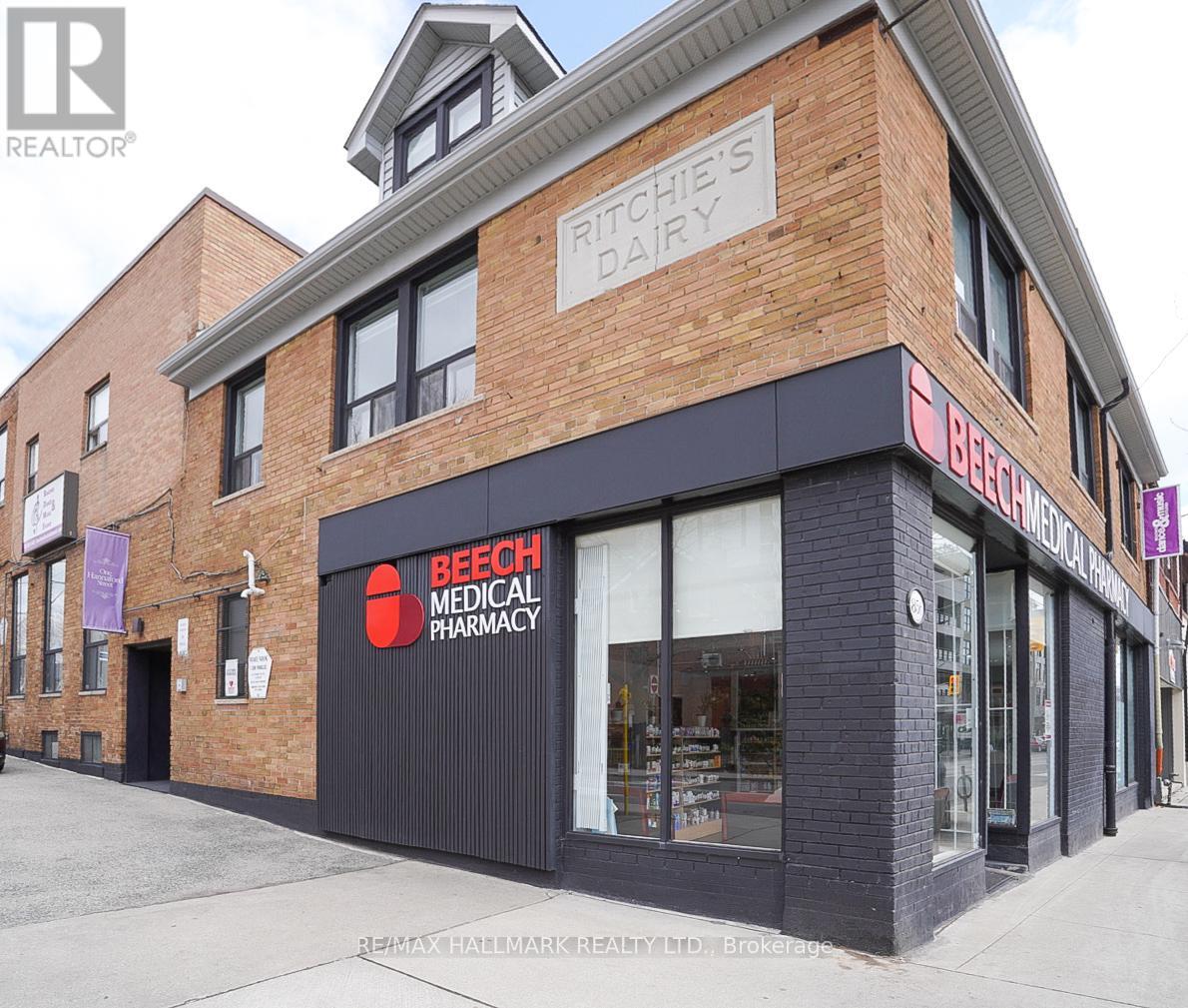 A brick building with a Beech Medical Pharmacy on the ground floor.