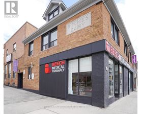 A brick building with a Beech Medical Pharmacy on the ground floor.