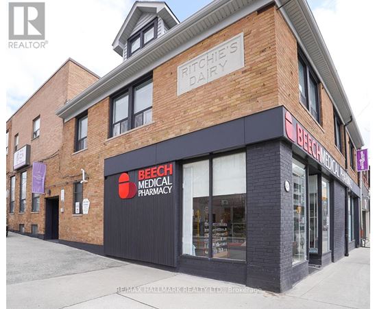 A brick building with a Beech Medical Pharmacy on the ground floor.