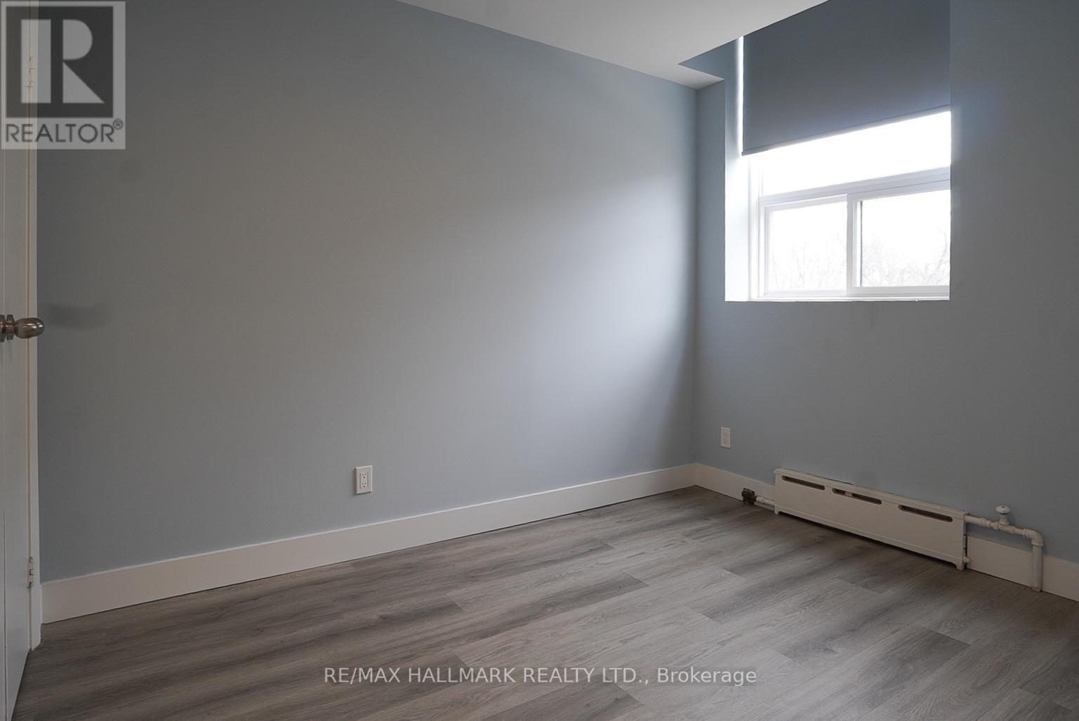 A room with a window and a door leading to another room.