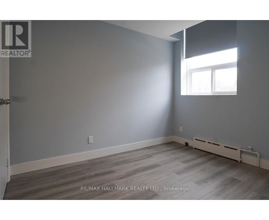 A room with a window and a door leading to another room.