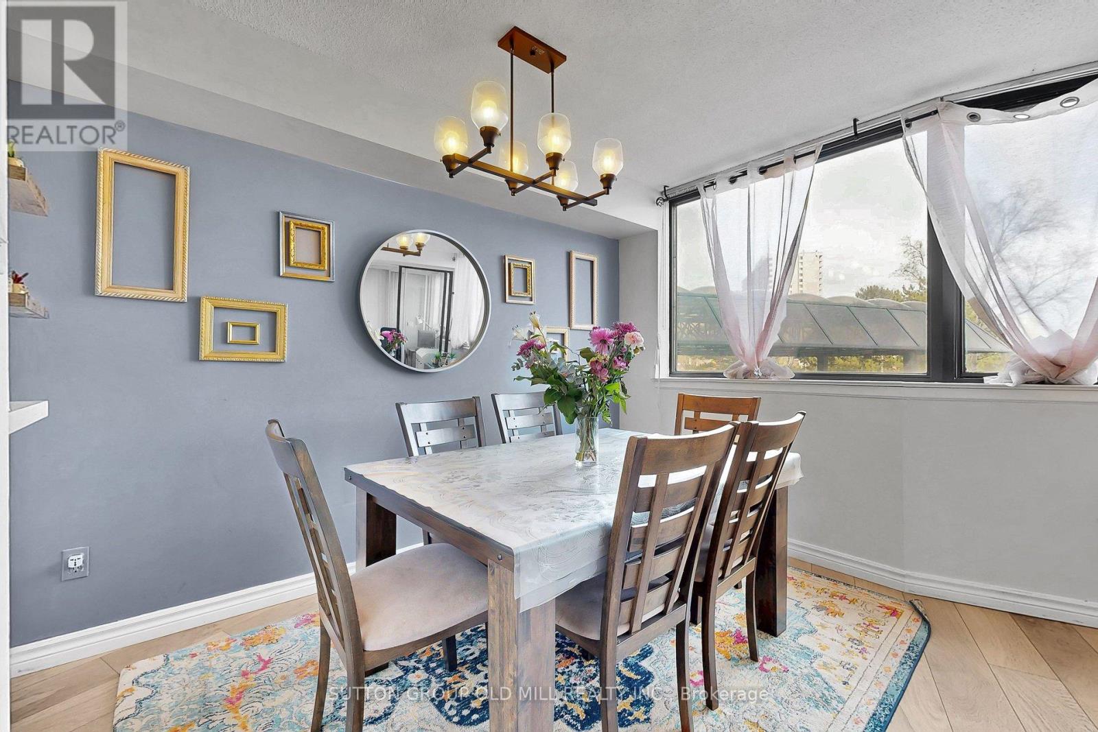 A dining room with a table and chairs.