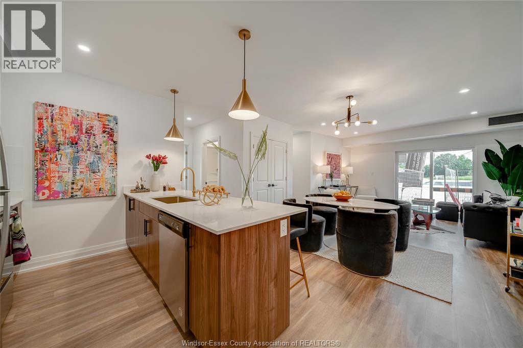A modern kitchen with wooden cabinets and a large island.