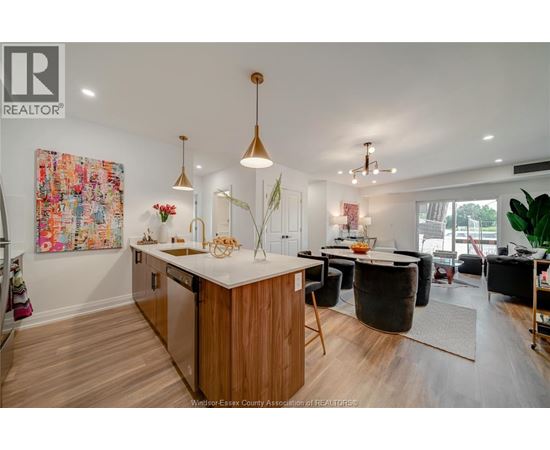 A modern kitchen with wooden cabinets and a large island.