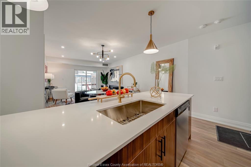 A modern kitchen with a large island and wooden cabinets.