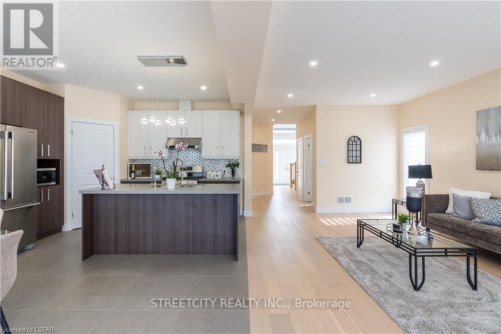 A modern kitchen and living room with a dining table and chairs.