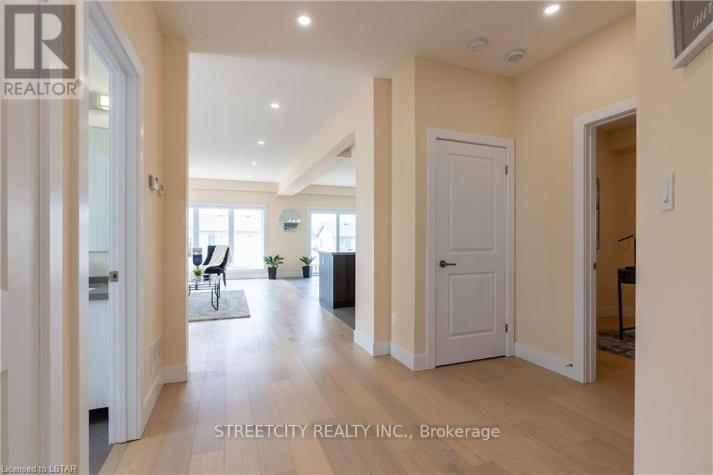 A spacious hallway with a chair and potted plants.
