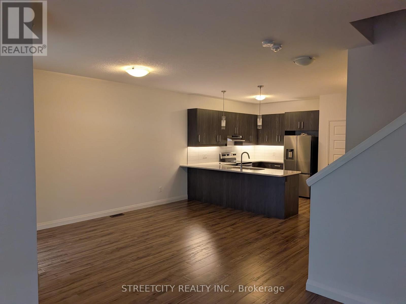 A kitchen with wooden floors and a countertop.