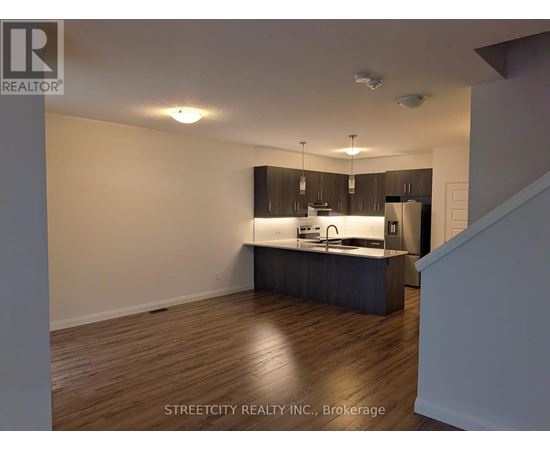 A kitchen with wooden floors and a countertop.