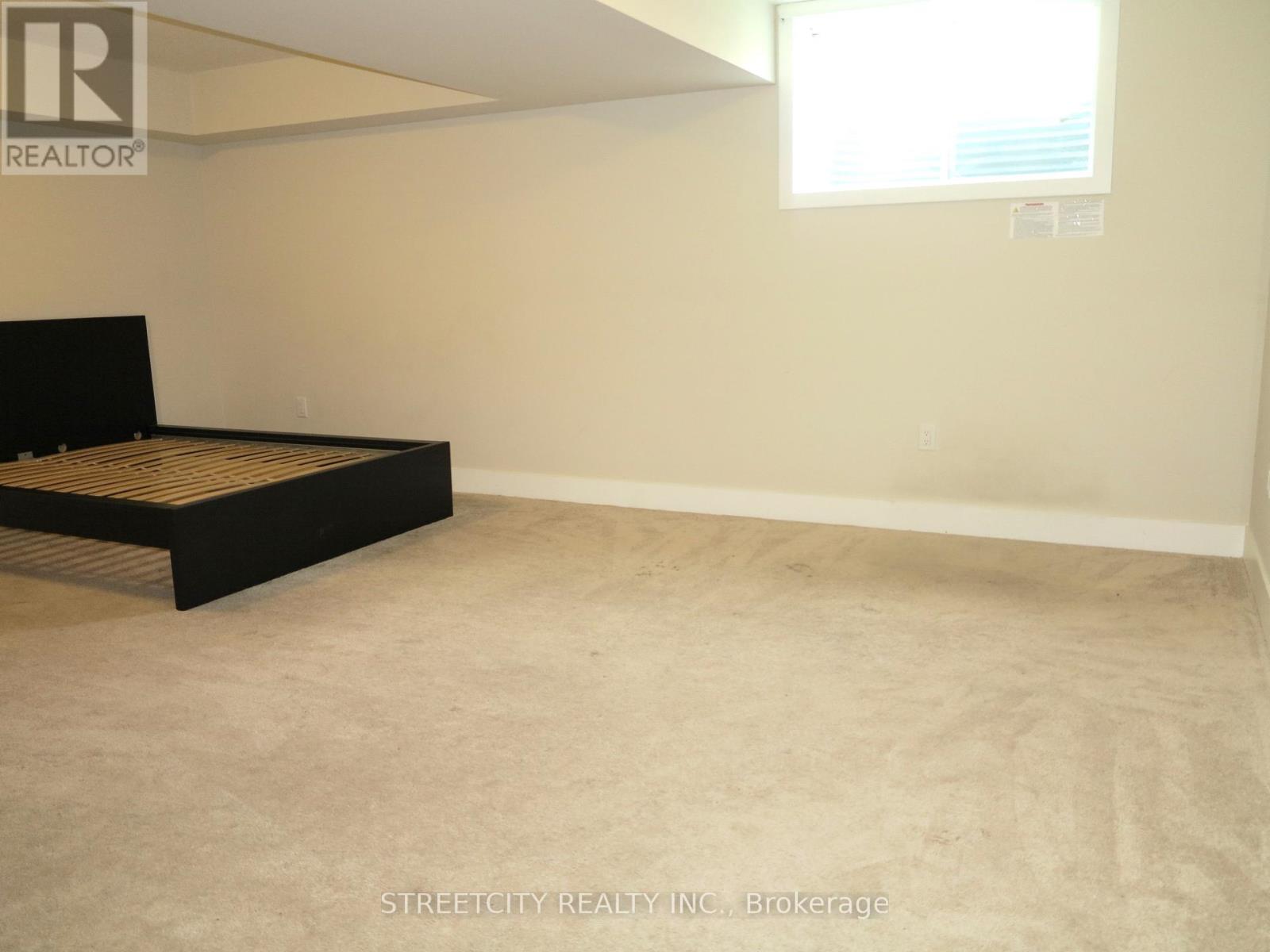A bedroom with a bed and a window.