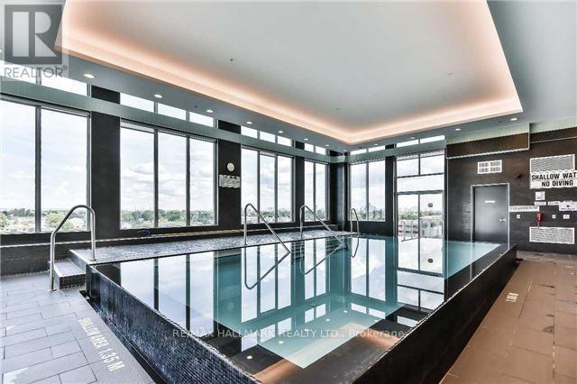 A large indoor swimming pool with a glass barrier and a sign that says "NO DIVING".