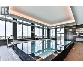 A large indoor swimming pool with a glass barrier and a sign that says "NO DIVING".
