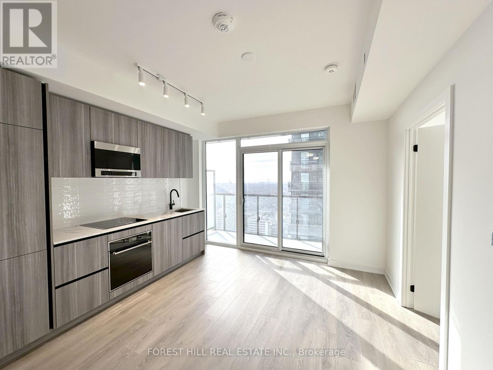 A modern kitchen with wooden cabinets and stainless steel appliances.