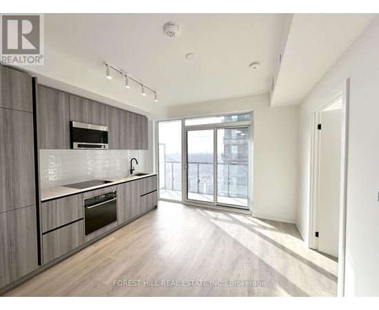 A modern kitchen with wooden cabinets and stainless steel appliances.