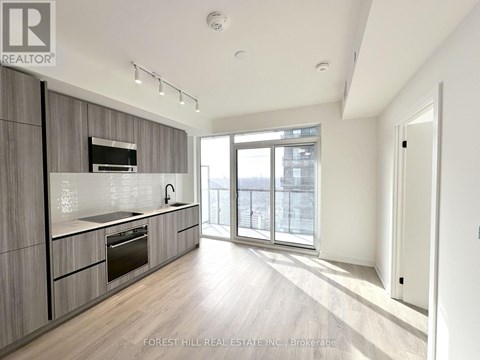 A modern kitchen with wooden cabinets and stainless steel appliances.