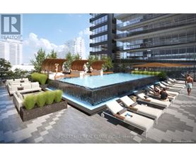 A pool area with lounge chairs and a waterfall feature.