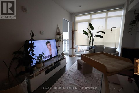 A living room with a television and a couch.