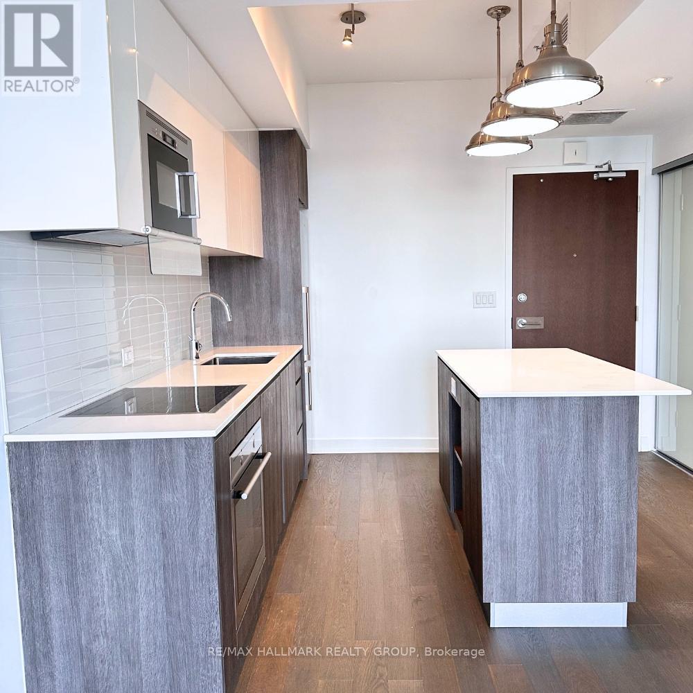 A kitchen with a sink and a microwave.