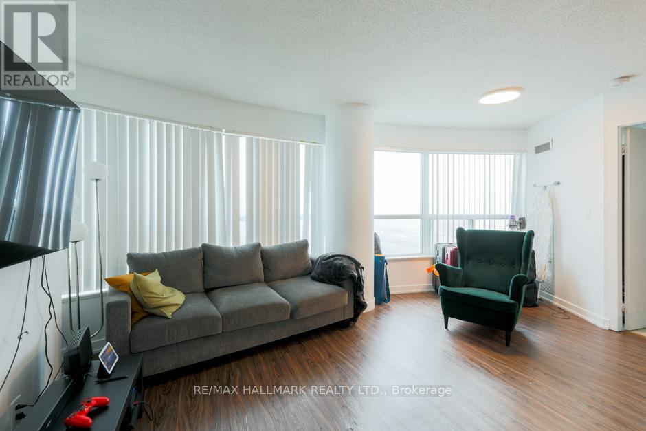 A living room with a grey couch and a green armchair.
