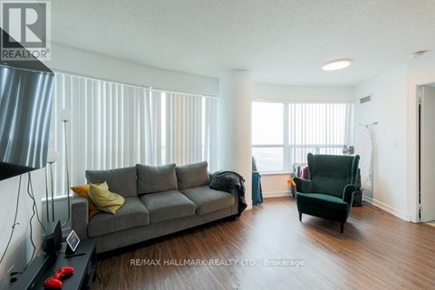 A living room with a grey couch and a green armchair.