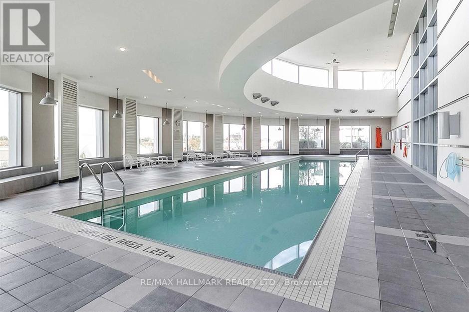 A large indoor swimming pool with a glass bottom.