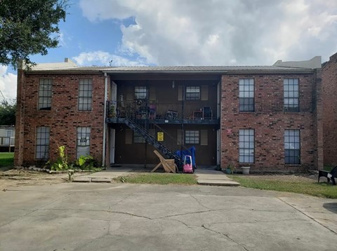 A brick building with a garage door open.