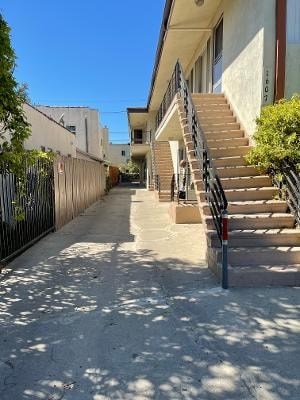 A narrow alley with a staircase leading to a building.