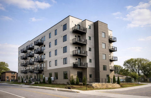 A modern apartment building with balconies on each floor.