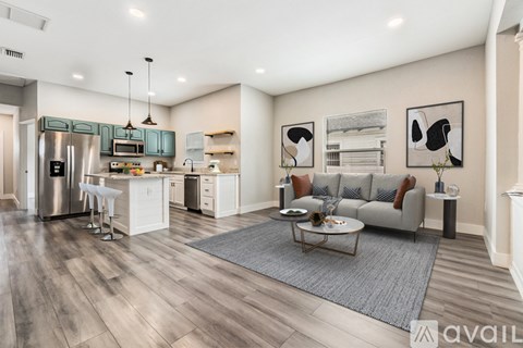 A modern kitchen with a dining table and a couch.