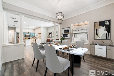 A modern dining room with a large table and chairs.