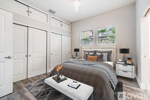 A bedroom with a large bed and a bench in front of it.