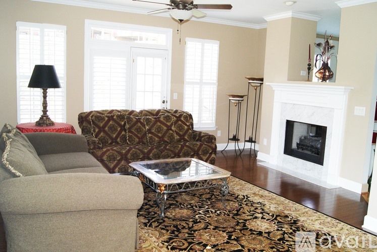 A living room with a fireplace and a chair.