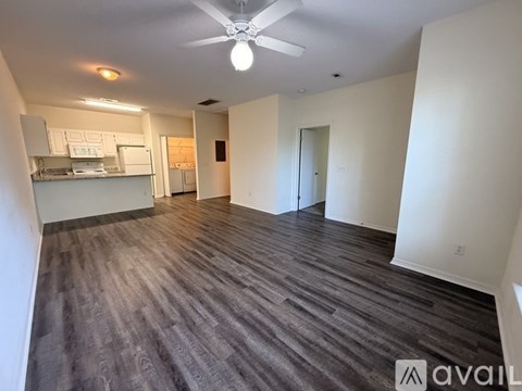 A kitchen with white appliances and cabinets.