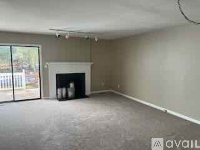 A living room with a fireplace and sliding glass doors.