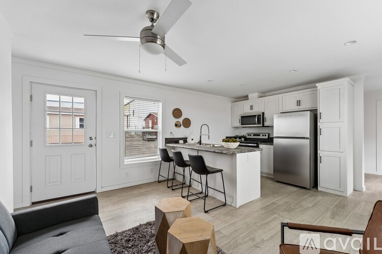 A modern kitchen with a dining table and chairs.