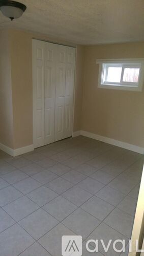 A room with a white door and a window.