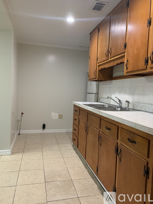 A kitchen with wooden cabinets and a sink.