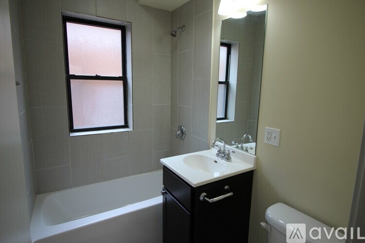 A bathroom with a white sink and a bathtub.