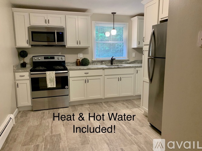 A kitchen with a stove, oven, microwave, and refrigerator is available for rent.