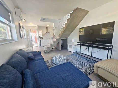 A living room with a blue couch and a television.