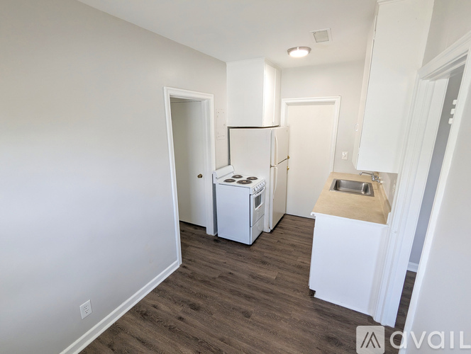 A kitchen area with a refrigerator, oven, and sink.