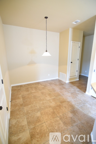 A room with a tiled floor and a hanging light fixture.