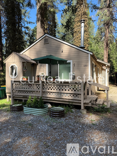 A house with a porch and a green awning is for sale.