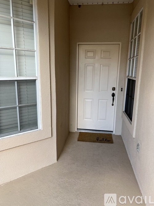 A white door with a doormat that says "Pullen" is on the right side of a hallway.