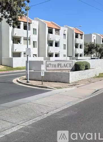 A street view of apartment buildings with a sign that reads "47TH PLACE".
