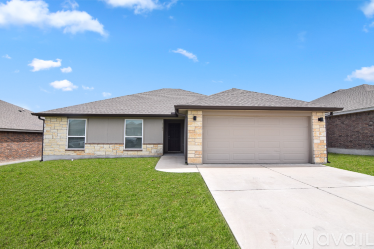 A house with a garage door and a driveway.