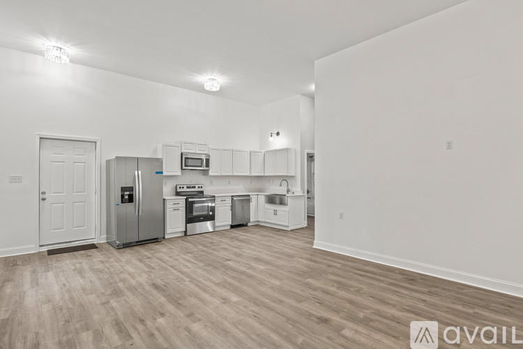 A spacious room with a ceiling fan and sliding glass doors.